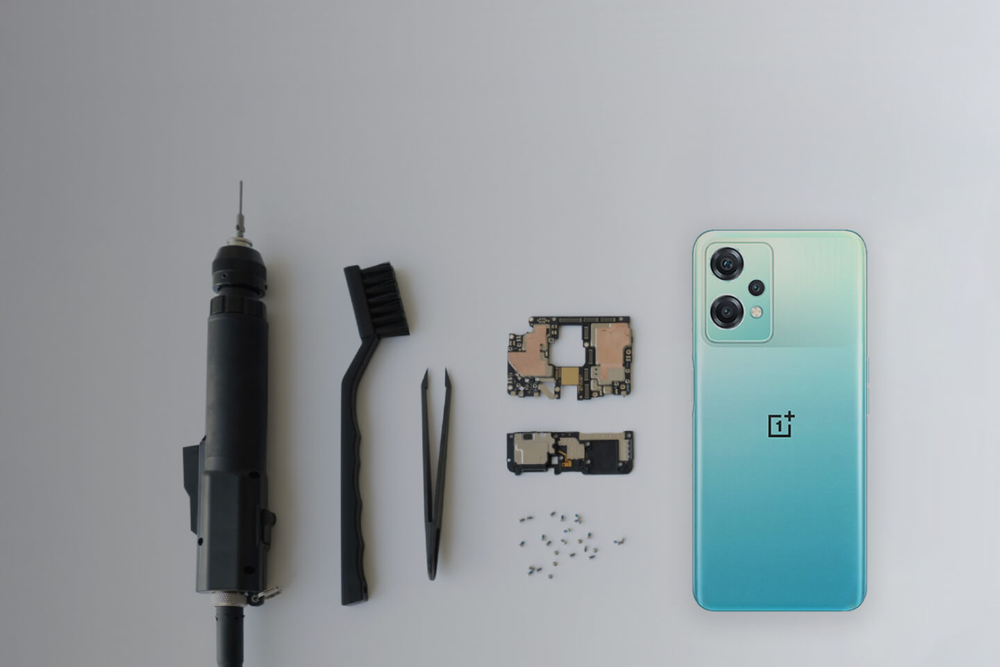 OnePlus repair tools and components with a OnePlus device